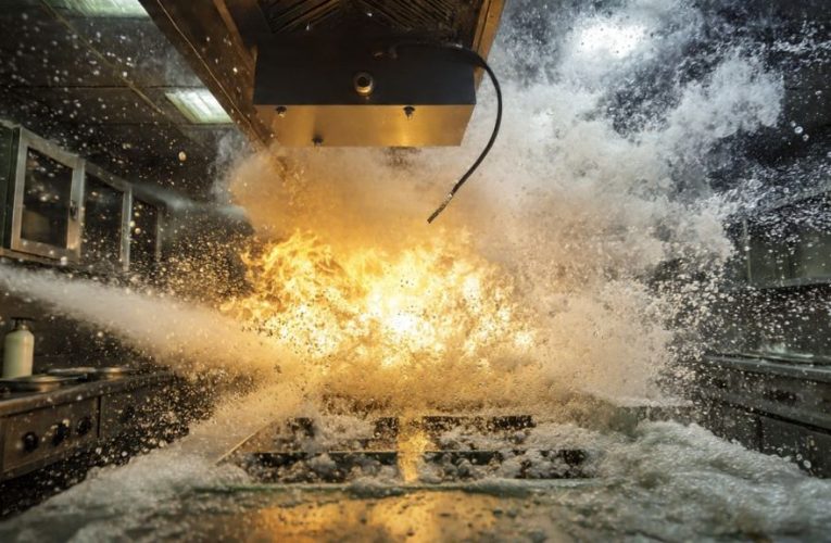 Automatic hood suppression system installed above commercial food truck cooking equipment with multiple nozzles