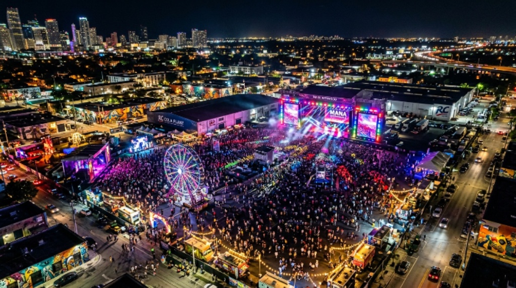 Aerial view of Mana Wynwood festival grounds at night with colorful stage lights