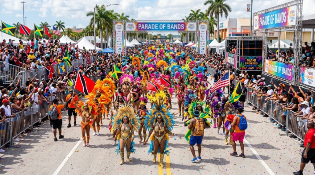 Thousands of colorful masqueraders marching through the Parade of Bands route at Miami Broward Carnival 2026 at the Miami-Dade County Fairgrounds